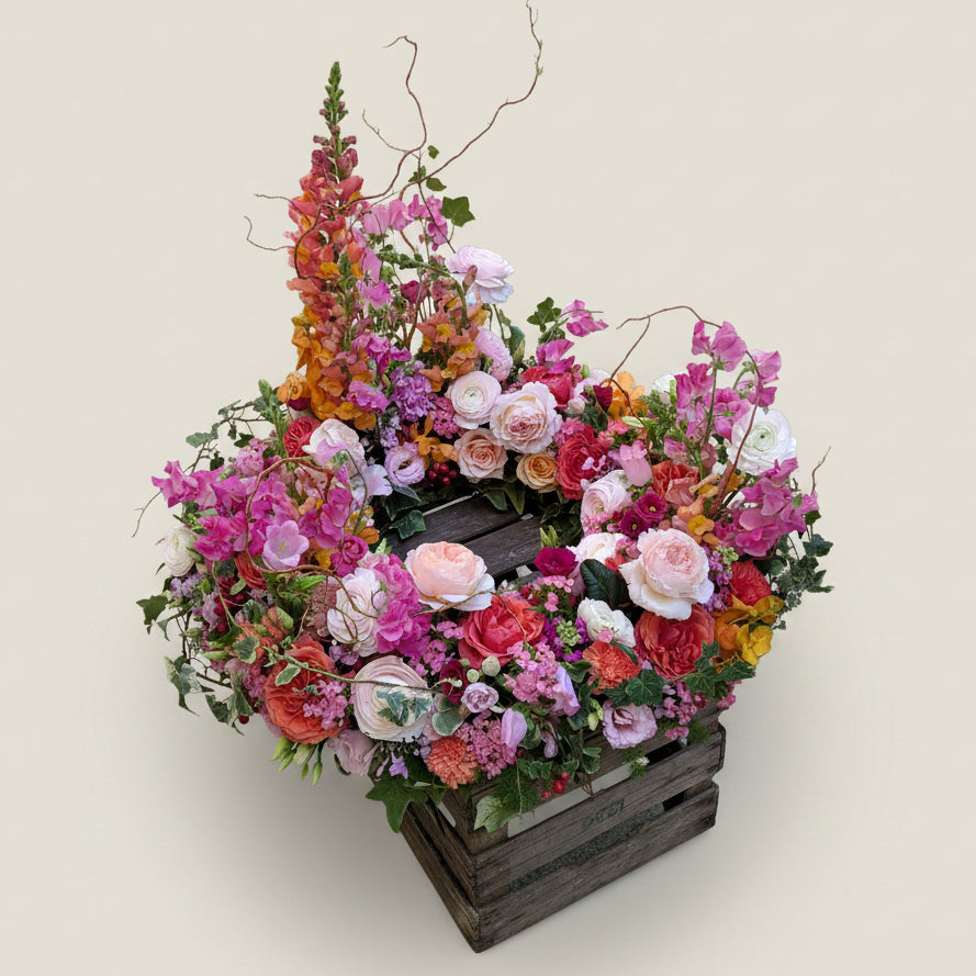 Coronne de fleurs colorées pour obsèques Symphonie réalisée par Arc en Ciel Fleurs 